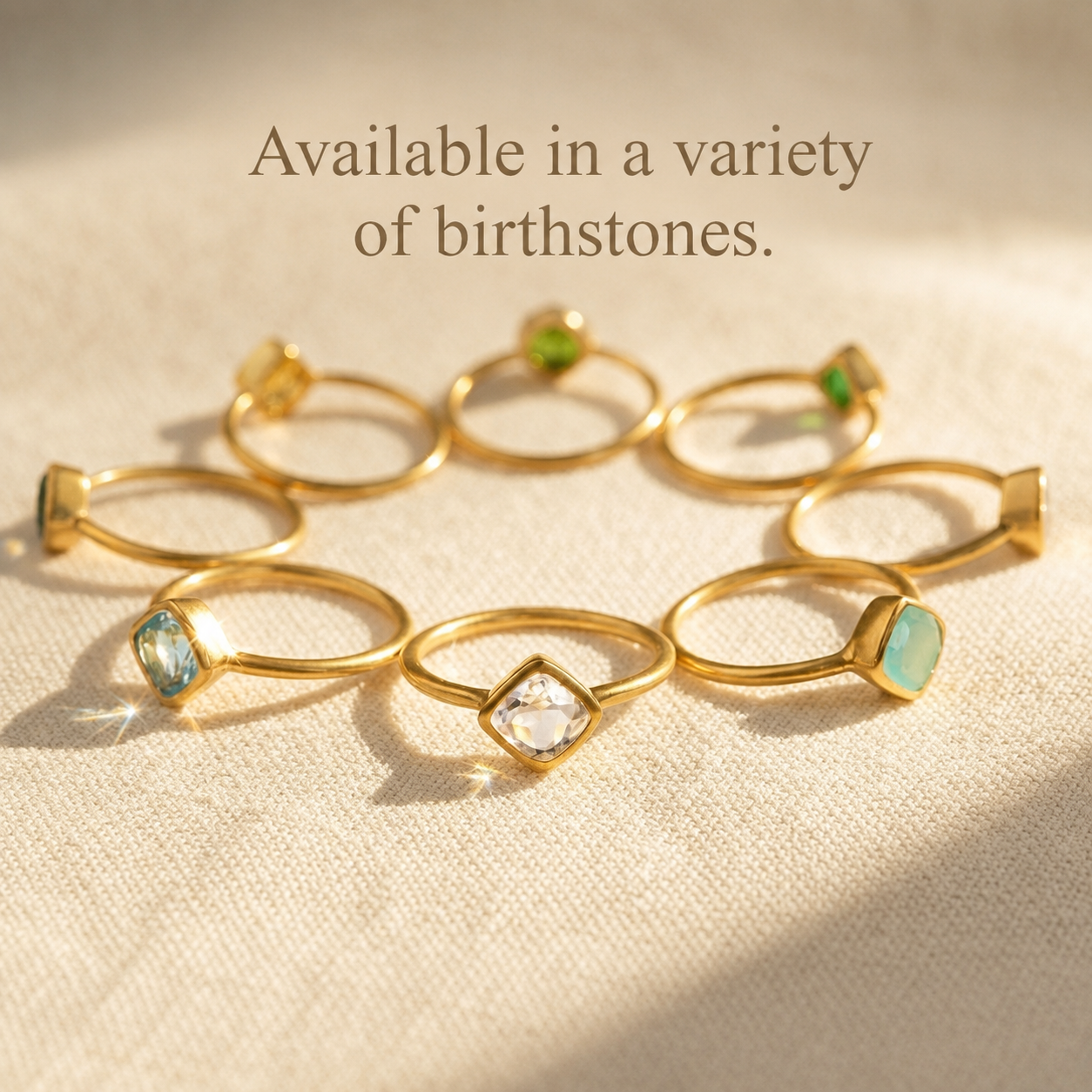 Gold gemstone rings arranged to show a variety of available birthstones