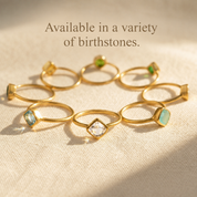 Gold gemstone rings arranged to show a variety of available birthstones