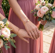 Bridesmaid wrist photo wearing personalized birthstone bracelet with engraved initial charm, dainty custom jewelry gift for wedding party or best friend
