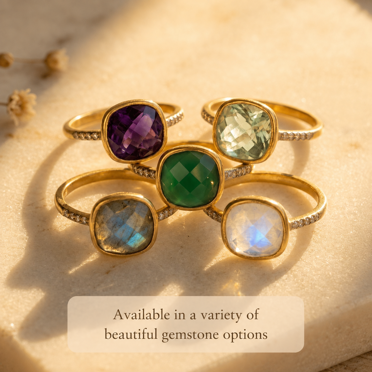Cushion-cut pavé rings displayed in several gemstone colors and metal finishes.