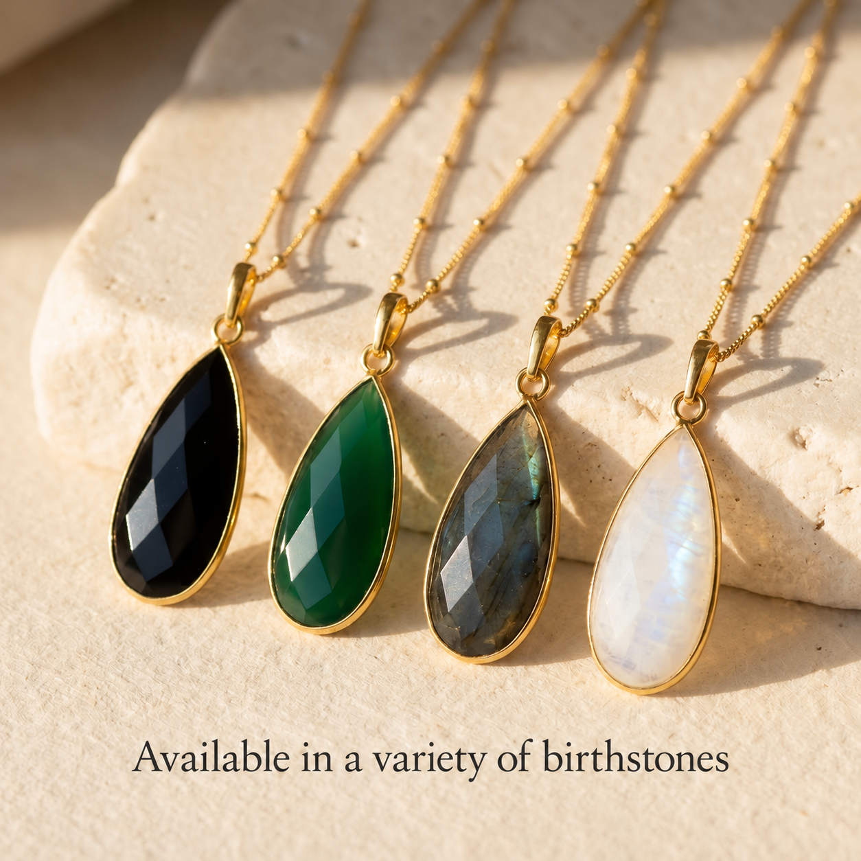 Teardrop gemstone pendant necklaces shown in multiple natural gemstone colors and gold settings.
