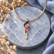 Boho curling spiral necklace with pink purple and rose gold abstract pendant on gray stone