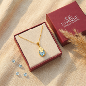 Personalized blue topaz name necklace displayed in a burgundy Danique Jewelry gift box