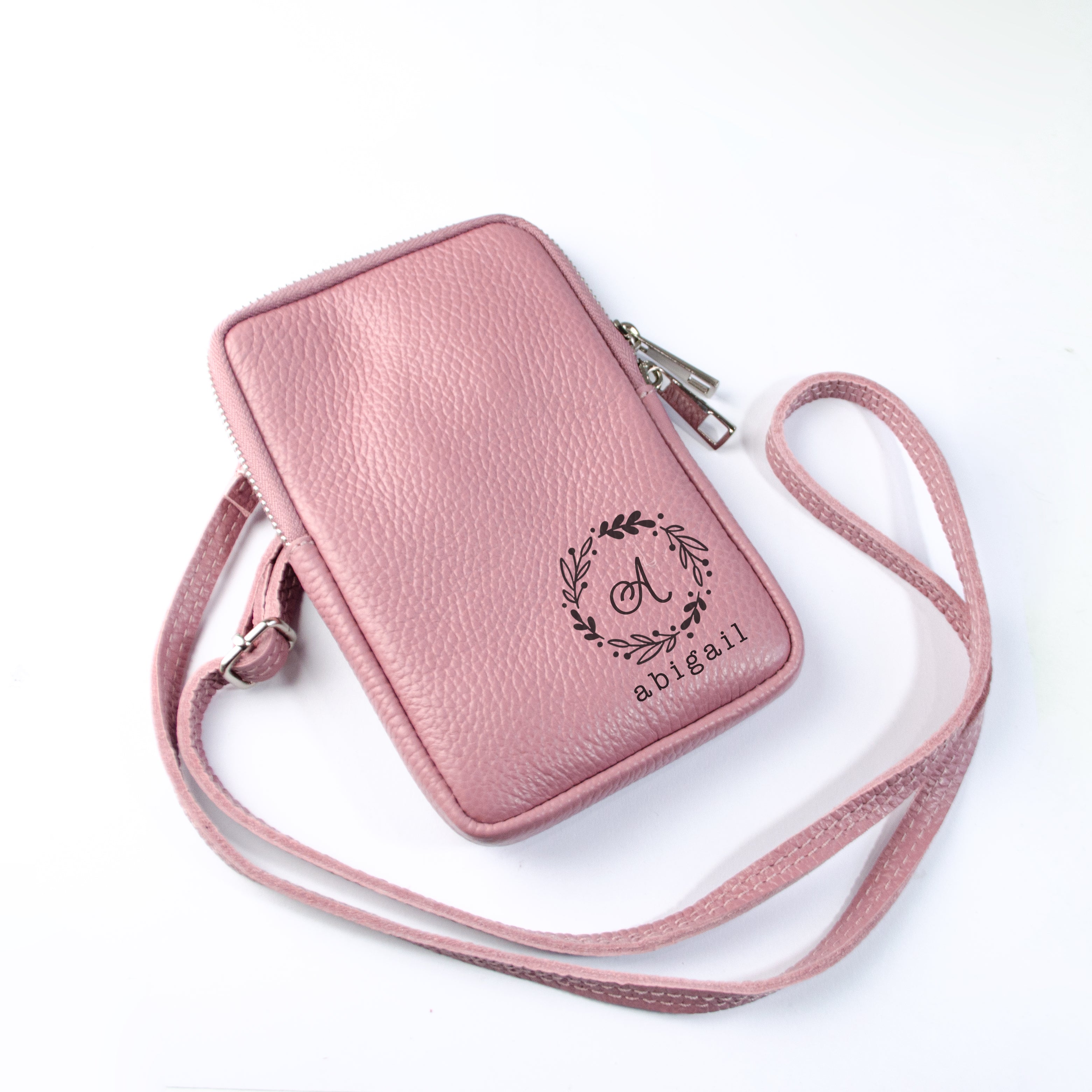 Genuine leather phone bag in dusty rose with wreath monogram. 