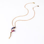 Adjustable Necklace with a copper rolo chain and a tapered spiral pendant plated in rose gold and painted in purple and pink enamel against a white background