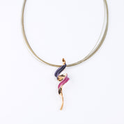 Adjustable Necklace with brown steel wire chain and a tapered spiral pendant plated in rose gold and painted in purple and pink enamel against a white background