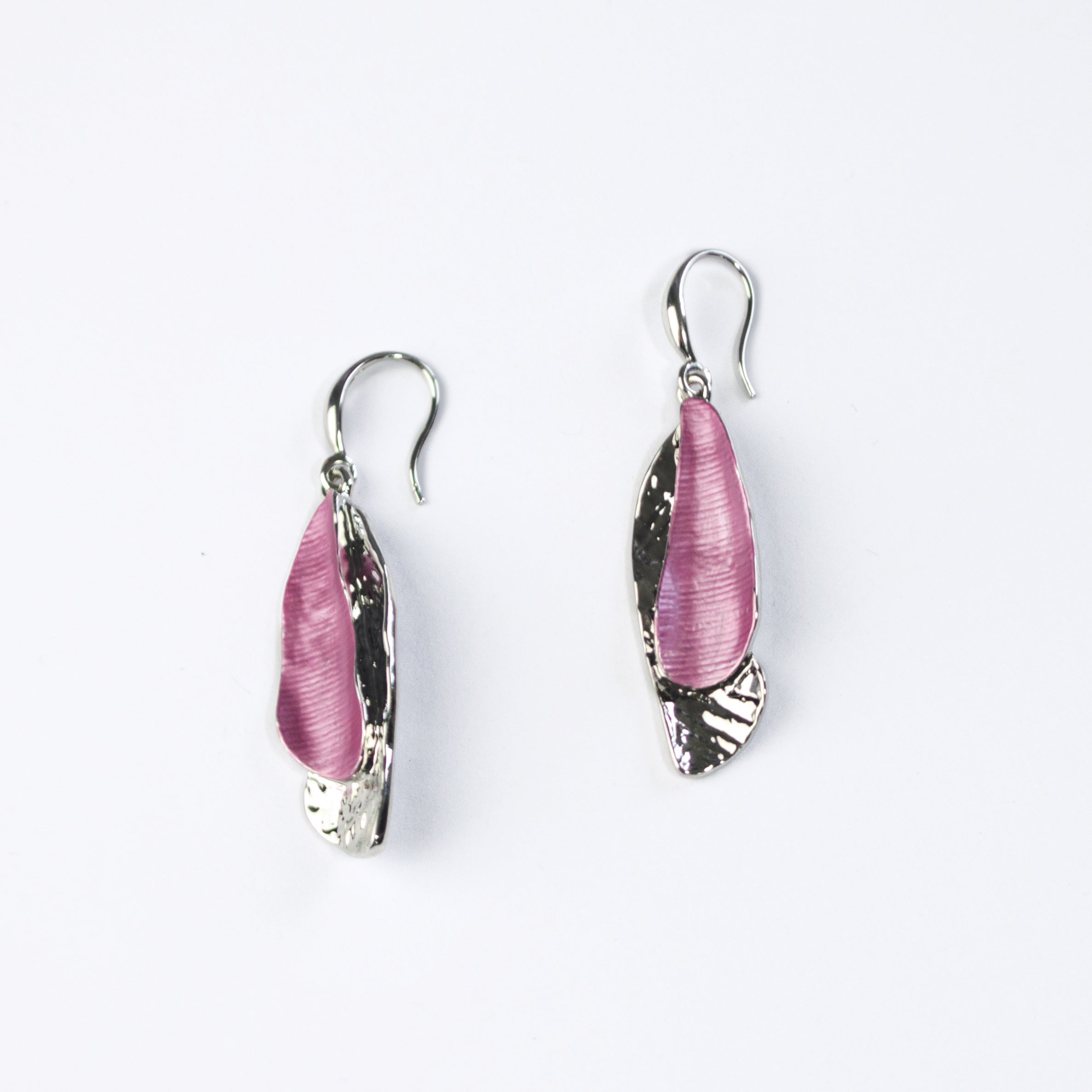 Hook Back Drop Earrings with pendants made of two overlapping textured organic shaped bars with the bottom bar plated in silver and the top painted in purple enamel sit against a white background