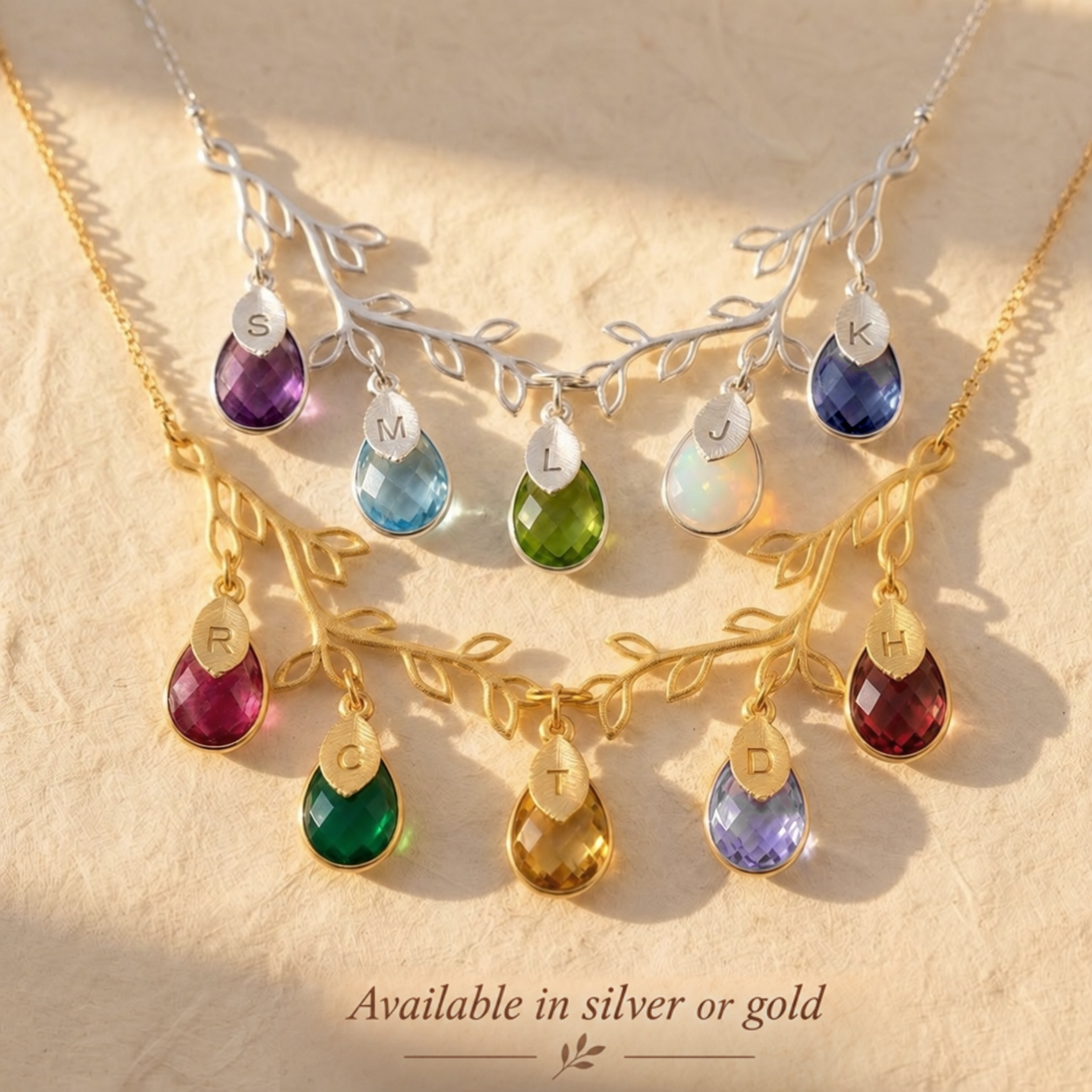 Silver and gold family tree necklaces with colorful kids birthstones
