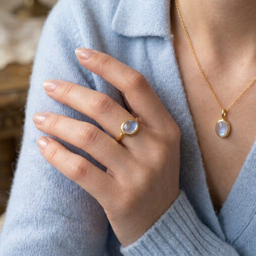 Dainty moonstone stacking ring and matching necklace shown on the model.