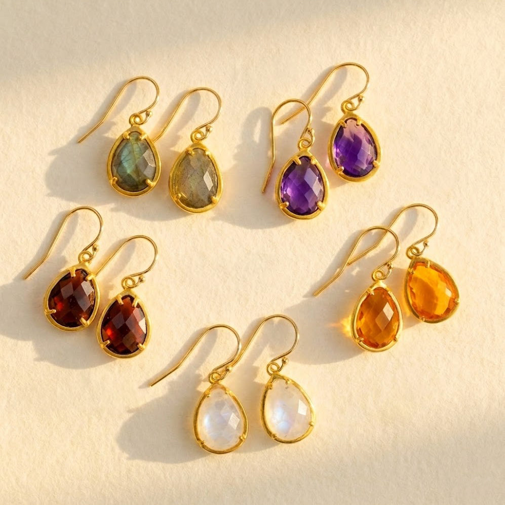 gold birthstone necklace and earrings set with teardrop stones representing kids and loved ones