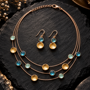 Boho floating circles necklace and matching earrings in Sea Glass Glow colors on dark stone

