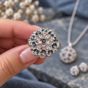 Hand holding Constellation Orb statement ring with sparkling aqua and clear accents

