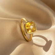 Cushion-cut citrine gemstone ring in 18K gold vermeil, featuring a radiant golden-yellow faceted November birthstone symbolizing joy and abundance. Handcrafted bezel-set design with modern minimalist elegance, perfect as a statement ring, engagement alternative, or personalized birthday and anniversary gift for her. Made with genuine citrine and polished gold band for timeless brilliance.