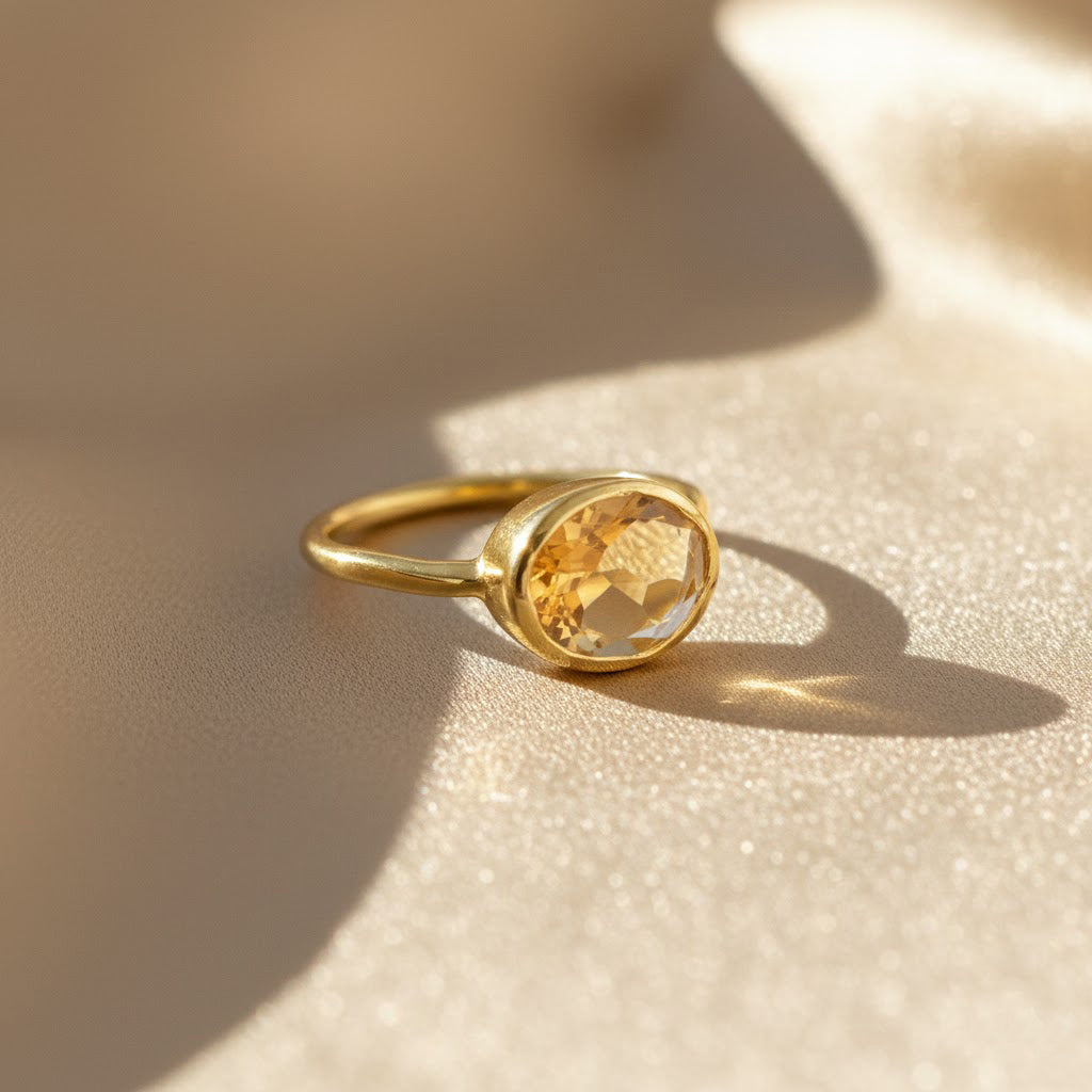 Oval-cut citrine ring in 18K gold vermeil, faceted yellow-orange gemstone set in a sleek bezel, handcrafted November birthstone ring symbolizing warmth and joy, timeless gold statement jewelry for her.
