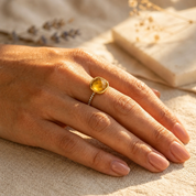 Golden citrine November birthstone ring with white topaz pavé shown on a woman's hand