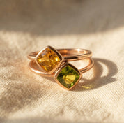 Citrine and peridot gemstone rings stacked together in gold vermeil