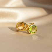 Citrine and peridot two-stone ring in gold, featuring faceted yellow and green gemstones symbolizing November and August birthstones, handcrafted bezel-set design, personalized birthstone jewelry gift for her.