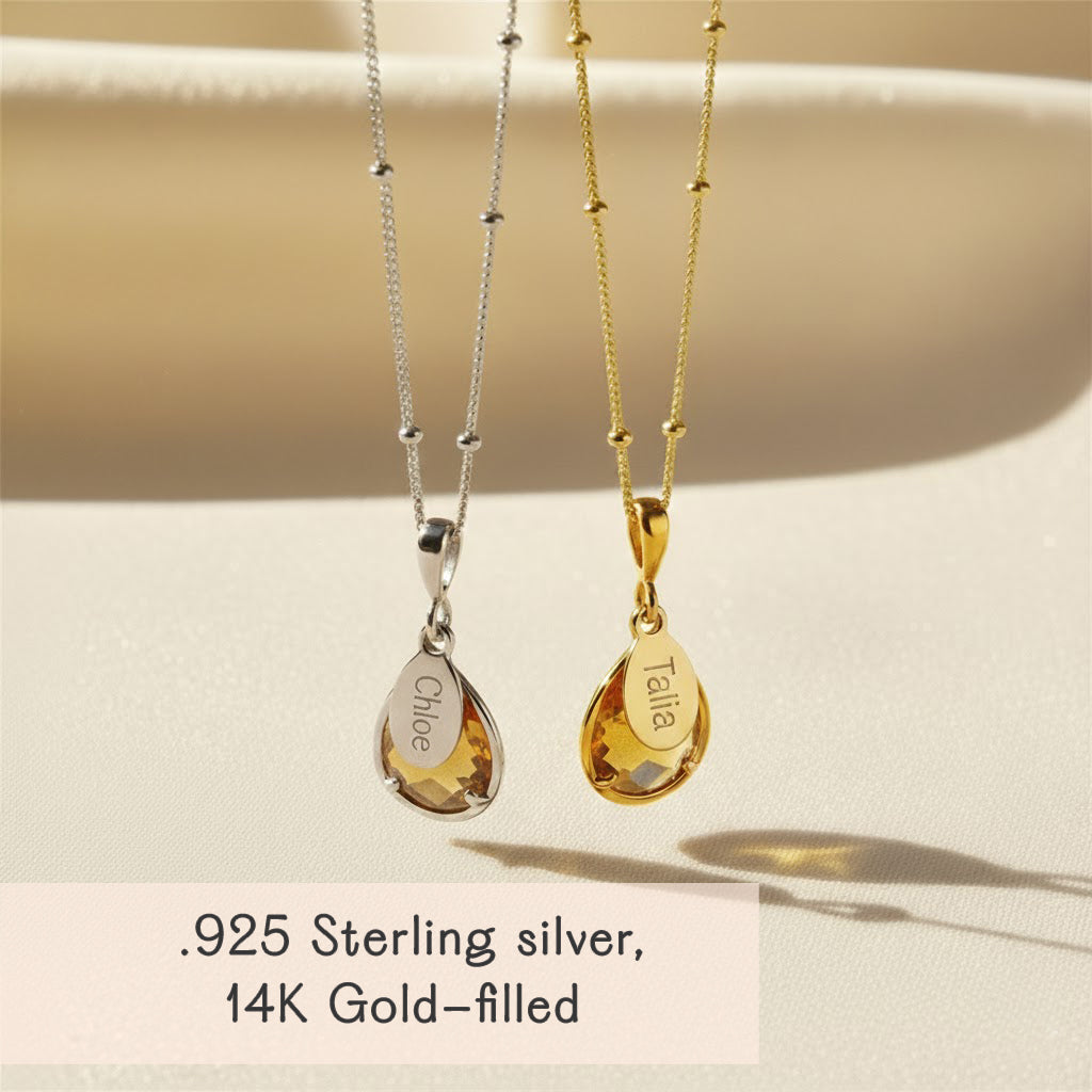 Citrine November birthstone pendant necklaces displayed in both sterling silver and 14k gold-filled finishes, each featuring a prong-set teardrop citrine gem paired with a custom engraved name tag. Personalized citrine necklace makes a beautiful November birthday gift for mom or grandma. Dainty layered necklace style perfect for everyday wear and gifting during Mother’s Day or Christmas.