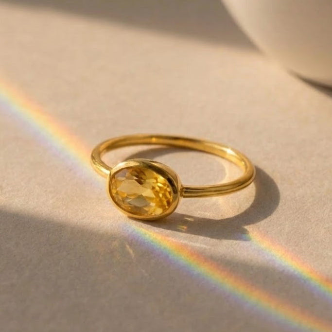 Small oval citrine birthstone ring featuring a golden November gemstone in a minimalist setting, handcrafted in sterling silver or gold vermeil.