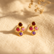 Custom four birthstone stud earrings with natural 3mm gemstones in yellow gold vermeil on warm beige fabric