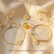 Matching constellation jewelry set with necklace, bracelet, and ring in yellow gold finish.