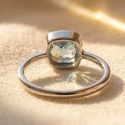 sterling silver blue topaz cushion cut ring on white background, bezel set aquamarine gemstone minimalist ring