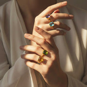 Custom birthstone rings in gold vermeil worn on hand, cushion cut gemstone rings in multiple colors including amethyst, blue topaz, peridot and citrine, personalized minimalist statement jewelry for women