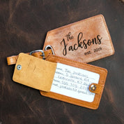 A honey luggage tag engraved with the Family monogram sits on a granite background. The back flap is open revealing a card with information written on it.Family Name Engraving Luggage Tag With ID Card Window Light Brown Leather Color natural leather travel bag tag, identification tag for luggage
