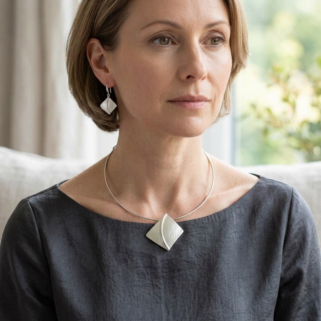 Woman wearing Soft Pearl sculpted leaf pendant necklace with modern minimalist styling


