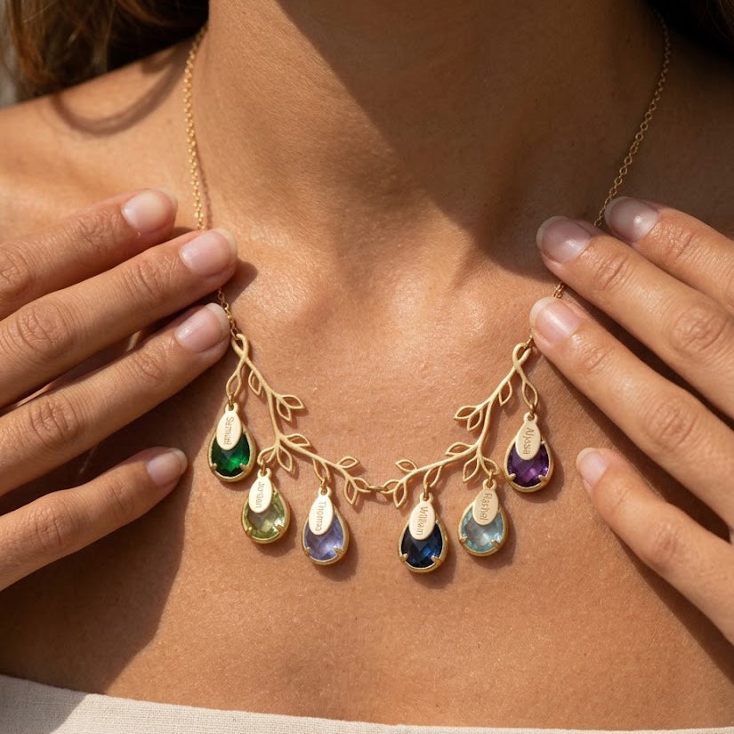 Woman wearing a personalized double-branch family tree birthstone necklace with children's engraved names.
