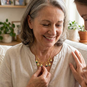 Grandmother wearing a personalized family tree necklace with grandchildren's birthstones and engraved names.
