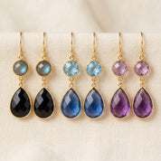 Custom double drop birthstone earrings with round and teardrop gemstones in labradorite, blue topaz, and amethyst.