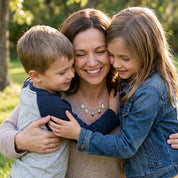 Mother with son and daughter wearing a personalized family tree birthstone necklace outdoors.