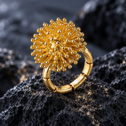 Gold Dandelion Puff adjustable statement ring with sculptural floral design on dark textured stone