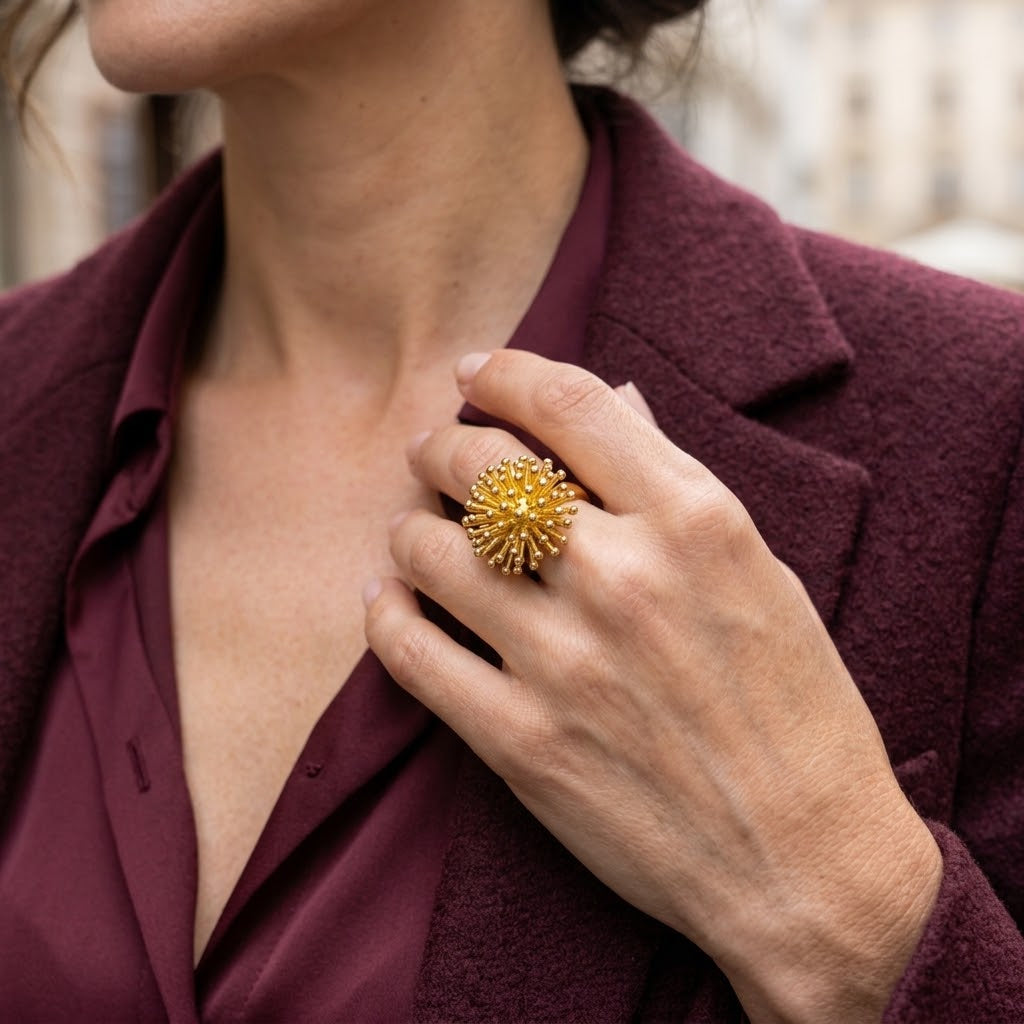 Woman wearing Gold Dandelion Puff statement ring with burgundy blazer

