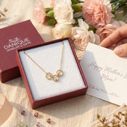 Personalized family birthstone circle necklace displayed in Danique Jewelry signature gift-ready packaging.
