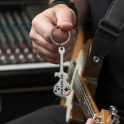 Personalized guitar bottle opener keychain held next to guitar, featuring engraved stainless steel design. Custom music-themed keychain gift for guitar players, musicians, and dads.