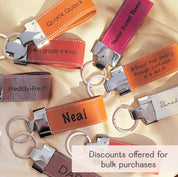 Colorful assortment of personalized large leather keychain loops, each custom engraved with names, quotes, or phrases like “Neal,” “Home Sweet Home,” and “Freddy-Fresh.” These durable keychains feature silver hardware and stitched detailing, ideal for teachers, dads, grads, coworkers, and bulk gifting. Perfect for custom promotional items, stocking stuffers, event favors, or employee appreciation gifts. Discounts available for group orders and personalized text options on each piece.