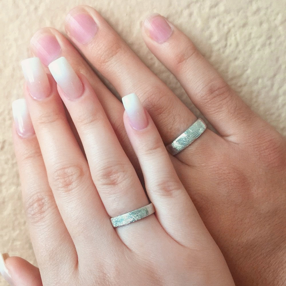 Couples displaying silver 4mm and 6mm rings. Gift for her, gift for him, memorial gift, commemorative gift, gift for fiance, gift for husband, gift for wife, gift for girlfriend, gift for boyfriend, silver anniversary gift, wedding gift, graduation gift, gift giving ready, christmas gift, valentine's day gift, birthday gift, family reunion gift, funeral gift, gift for those who lost loved ones, unique gifts for men, unique gifts for women. sterling silver band, finger band