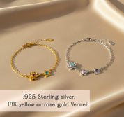 custom mom birthstone bracelet displayed in flat lay style with colorful children’s birthstones arranged in delicate Bloom flower-shaped settings handcrafted in sterling silver gold filled or rose gold filled personalized family jewelry adjustable chain thoughtful Mother’s Day gift sentimental mom jewelry celebrating each child through meaningful gemstones perfect for moms grandmas and new mothers elegant feminine floral birthstone bracelet design