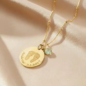 Gold filled necklace engraved with baby's footprints, name and date and add an optional birthstone charm to complete this perfect gift for mom on Mother's Day, for a push present, or birthday gift. 