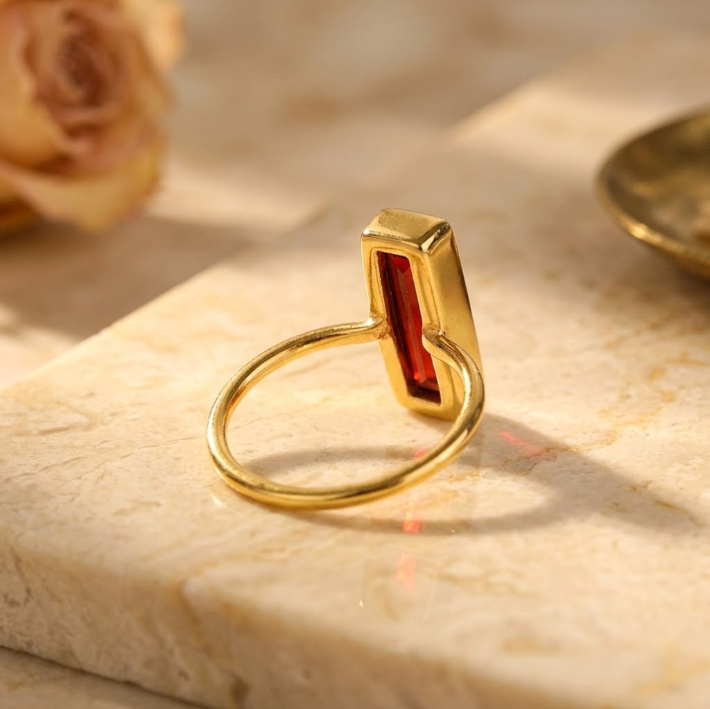 Side view of gold bezel set Garnet Quartz baguette ring