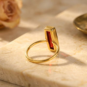 Side view of gold bezel set Garnet Quartz baguette ring