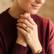 dainty garnet ring close up red gemstone bezel setting