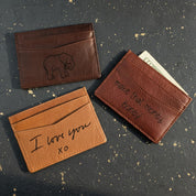 actual handwriting or drawing laser Custom engraved slim leather card holders featuring unique artwork designs including elephant engraving and “I love you xo” message. These personalized wallets make heartfelt gifts for boyfriends, husbands, or dads, and are ideal for anniversaries, Valentine’s Day, Christmas, or Father’s Day. Handcrafted from full-grain leather with multiple card slots, this minimalist card holder is stylish, practical, and deeply meaningful.