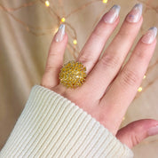 Model wearing a gold burst explosion statement ring - one size. fits sizes 7 and up, silver and gold plating. bold ring, boho ring, statement jewelry