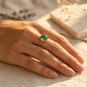 Gold-vermeil green onyx pavé ring worn on a hand in warm natural sunlight.
