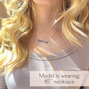 A person with blonde hair wears a beige shirt and a sterling silver engraved heartbeat necklace. Handmade baby keepsake jewelry, custom engraved bar necklace, personalized sonogram necklace, minimalist bar necklace for women, gold filled jewelry for her, sterling silver jewelry for her, personalized gift for new mom, push present for new mom, first mother's day gift, baby memorial keepsake for grieving mom