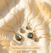 Matching labradorite necklaces and earrings arranged in sunlight, showing coordinated gemstone jewelry options for bridesmaids, birthdays, and gifts for her.