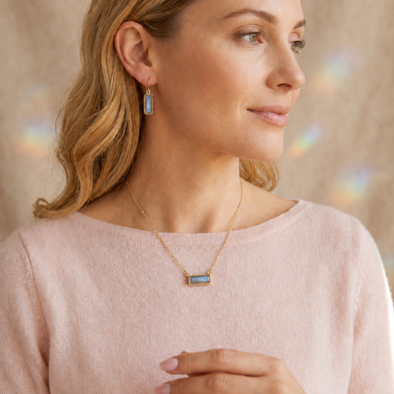 Woman wearing a personalized rectangular labradorite gemstone bar necklace in yellow gold